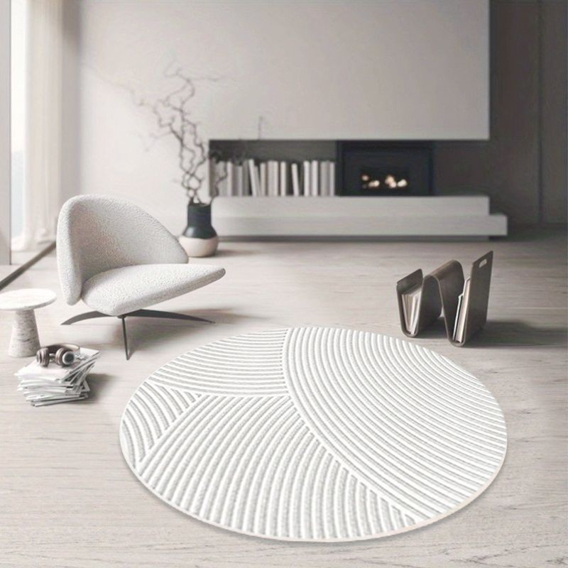 Tapis rond blanc à arcs sculptés et dos noir à picots fins