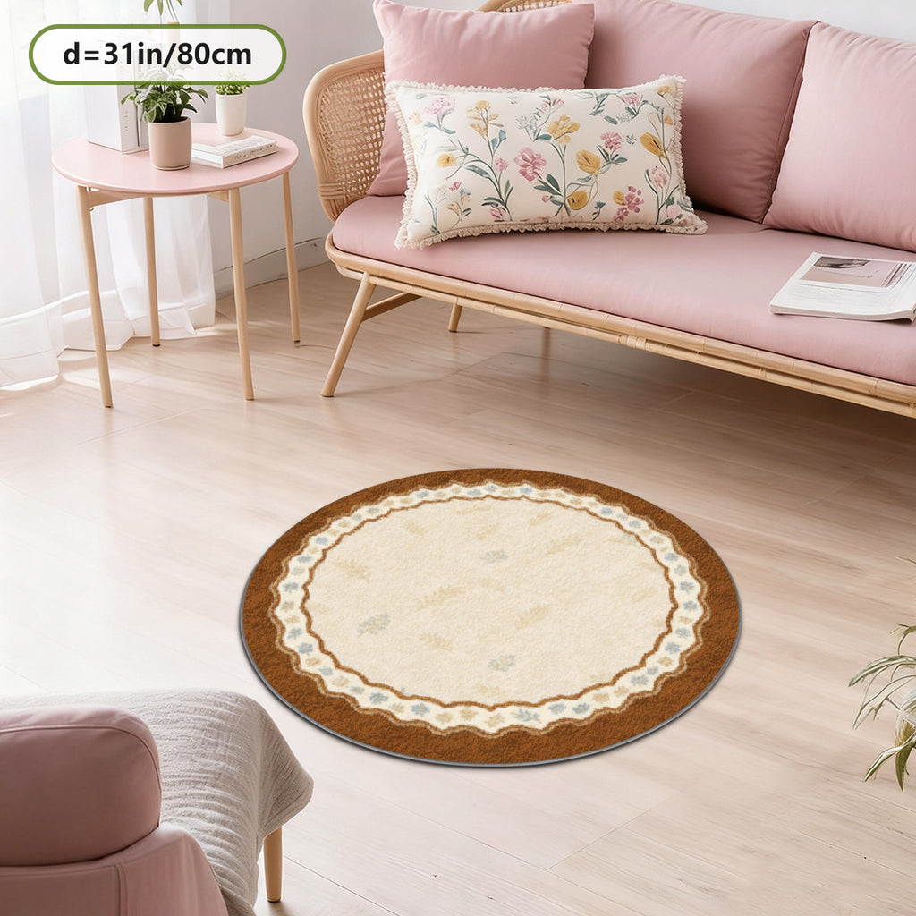 Tapis rond crème à large bord festonné brun, semis de brins