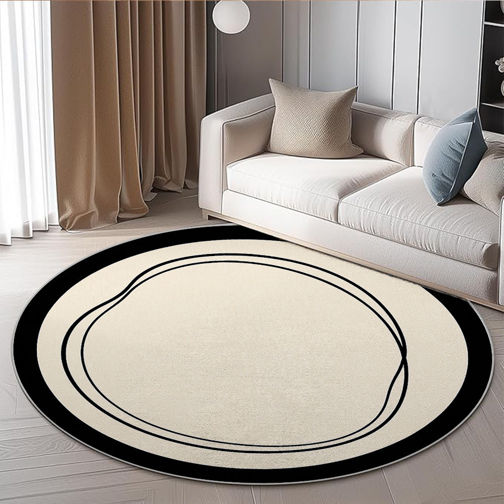 Tapis rond crème à large bordure noire et texture aplatie