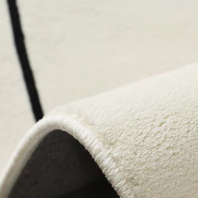 Tapis rond écru à pique ou tulipes noires, dos en vinyle