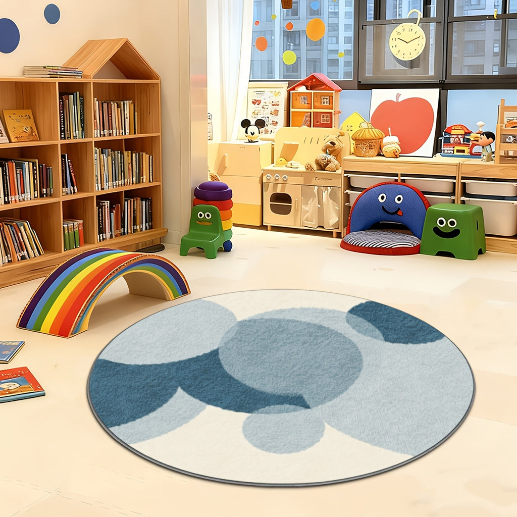 Tapis rond d'enfant à cercles bleus superposés sur crème
