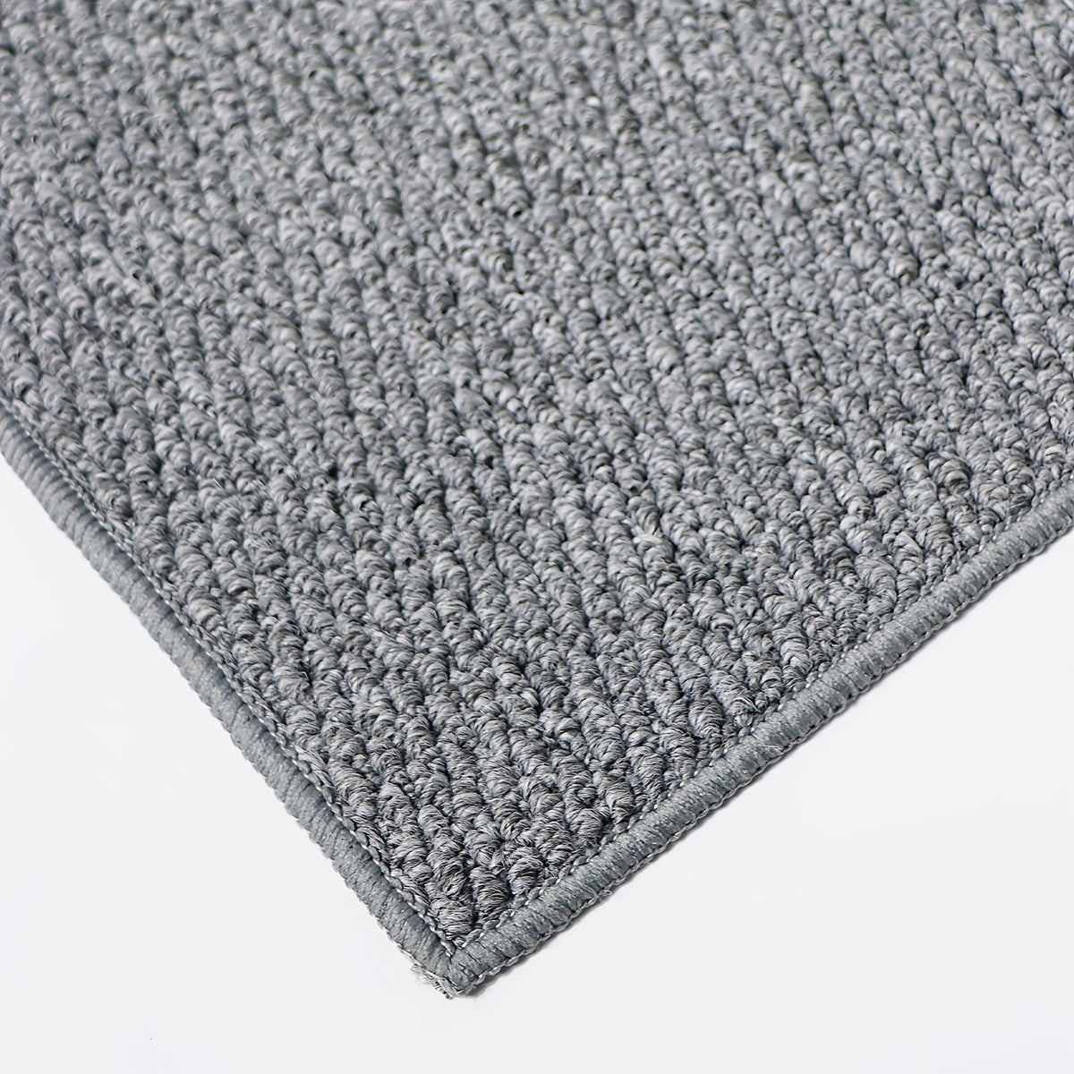 Tapis rond gris en maille bouclée, aspect fibre naturelle