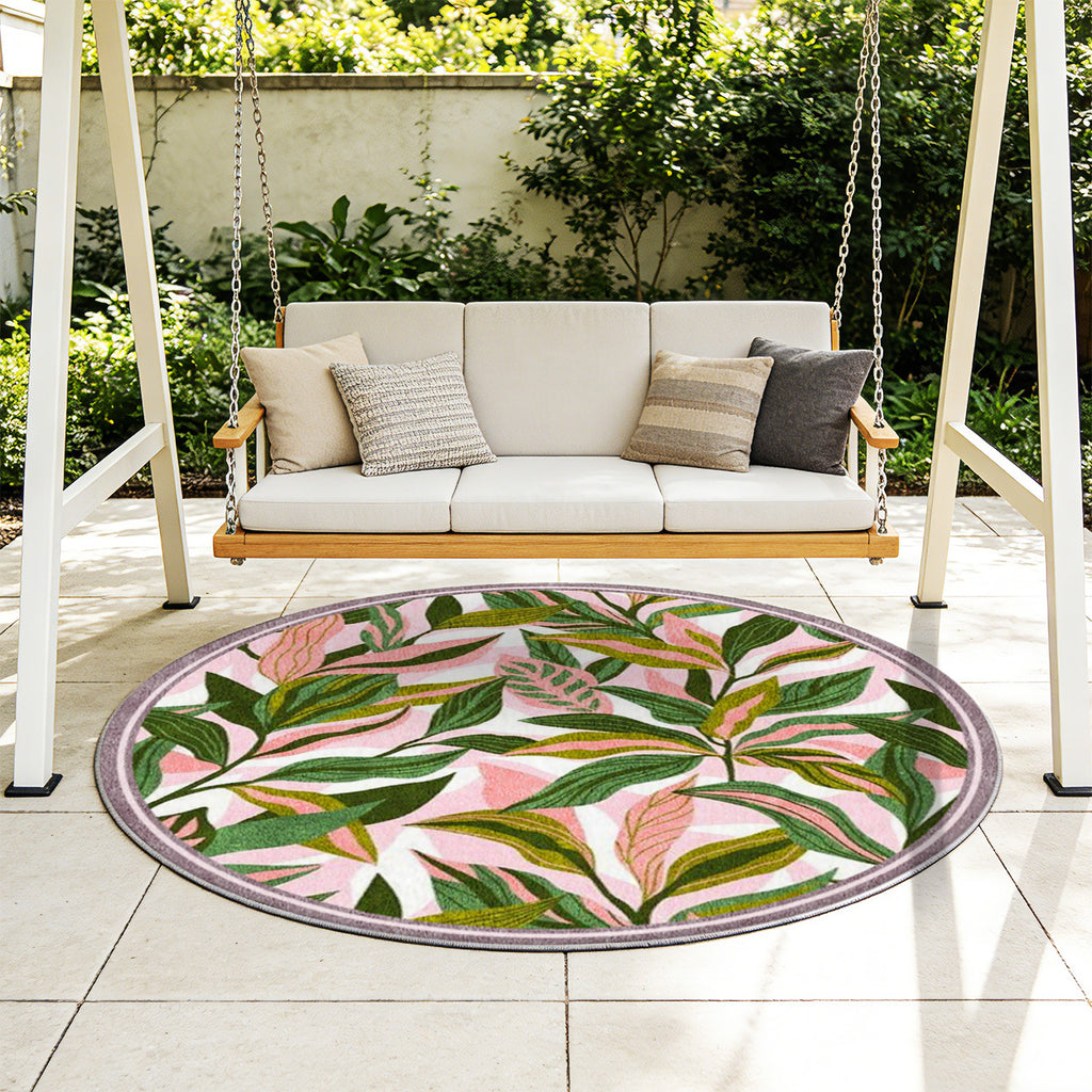 Tapis rond à feuillage vert sur fond rose, bordure mauve