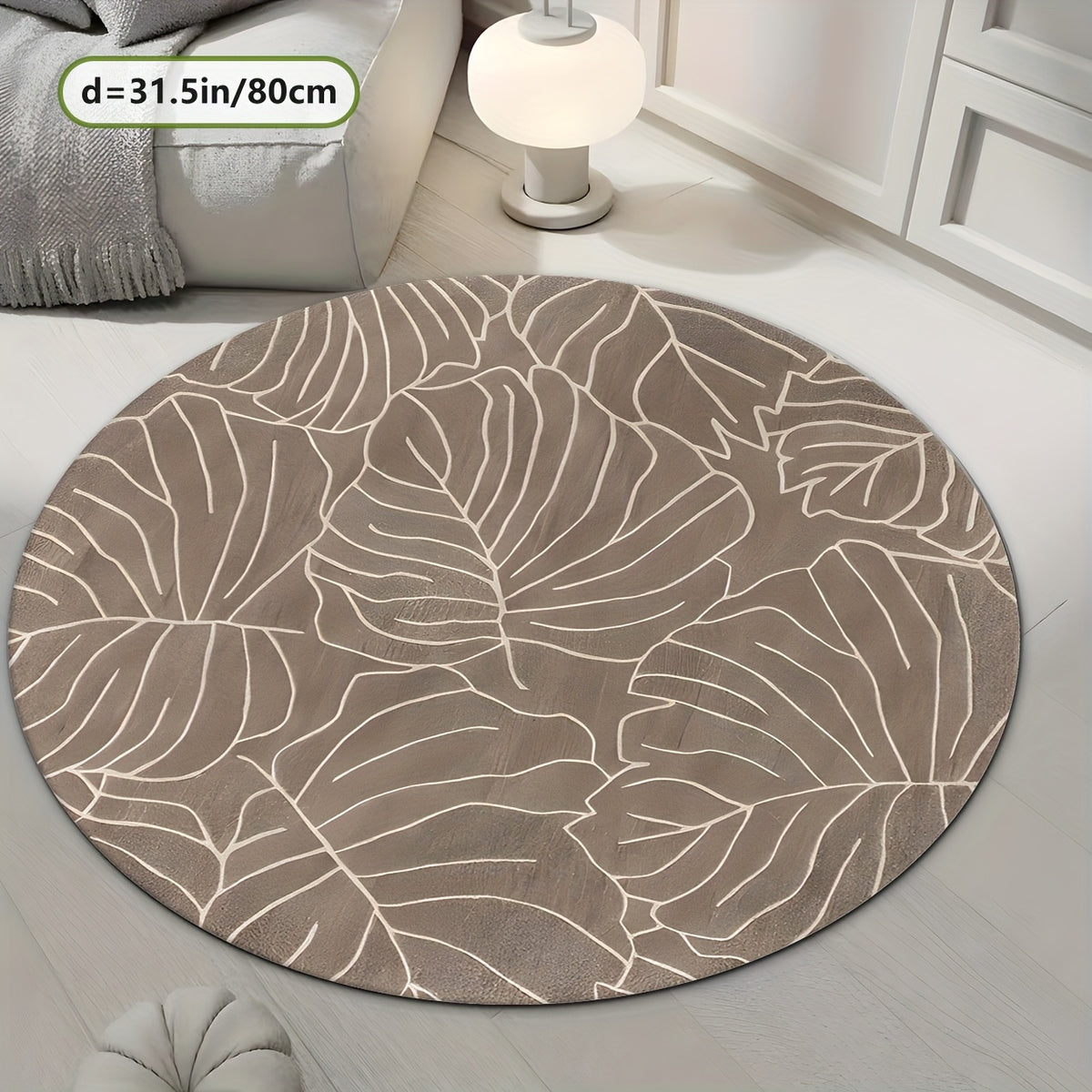 Tapis rond taupe aux grandes feuilles de monstera crème