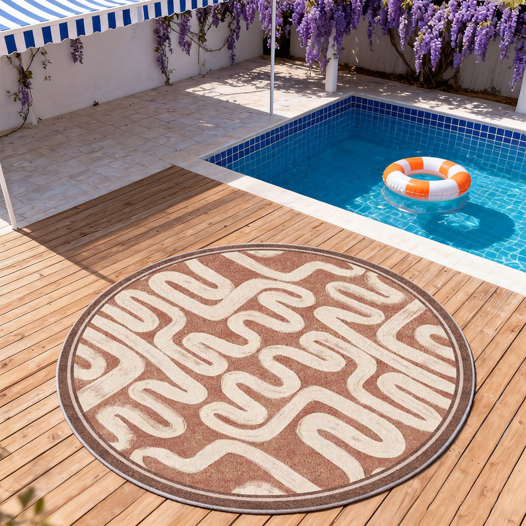 Tapis rond terracotta à serpentins crème et bordure large